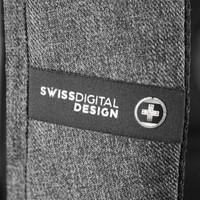 A close-up of a textured grey fabric with a logo patch featuring Swissdigital Design branding.