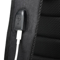 USB charging port on black backpack fabric.