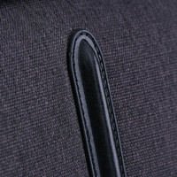 A close-up of a dark grey fabric with a black leather accent, part of the Swissdigital Arosa Duffle Bag.