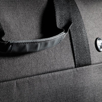 A black duffle bag featuring a textured fabric and a sturdy handle, with a logo visible on the side.