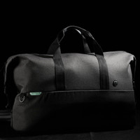 A black duffle bag with dual handles and a logo, featuring a sleek design and spacious interior.