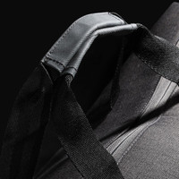 A black duffle bag featuring sturdy straps and a textured design, with branding visible on the surface.