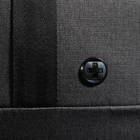 A black duffle bag with a textured surface and a circular logo on the side.