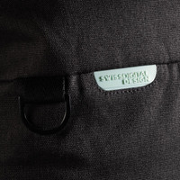 A black duffle bag featuring a light green logo tag and a metal loop attachment.