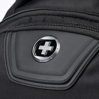 A close-up of a black backpack featuring a logo and a zipped pocket. The material appears durable and textured.