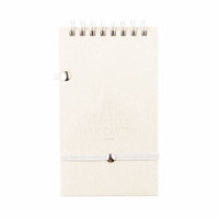 A white notepad made from recycled materials, featuring a spiral binding and a secure closure. It includes a pen.