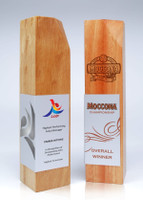 A wooden trophy with a polished finish, featuring metal accents and engraved text on both sides.