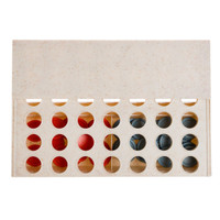 A rectangular game board in light beige with circular holes, featuring red and blue game pieces positioned inside.