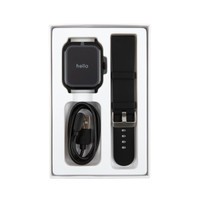 A black smart watch with a rectangular face, accompanied by a black strap and a charging cable, in a white box.