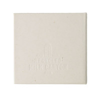 A square note block made from recycled materials, featuring a light cream colour and a subtle texture. It has a logo.