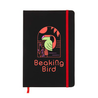 A black A5 notebook with a red elastic band, featuring a colorful bird design on the cover and a logo.