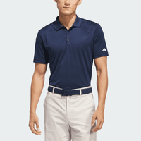 A navy blue polo shirt with a collar, short sleeves, and an emblem on one sleeve. The model is wearing light-coloured trousers.