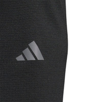 A close-up of a black pullover featuring a logo on the side. The fabric appears lightweight and textured.