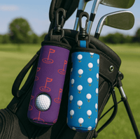 Neoprene golf ball sleeves in purple with flags and blue with golf balls, attached to a golf bag on a green field.