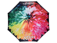 A large umbrella featuring a vibrant floral design in a mix of pink, green, and blue colours, with a logo on it.
