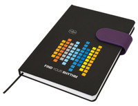 A black A5 notebook with a colourful graphic design and a purple elastic band closure. It features a logo.