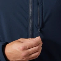 Close-up of hand zipping navy blue jacket.
