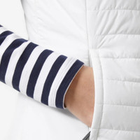 Close-up of a hand in a white puffer jacket pocket, striped sleeve showing.