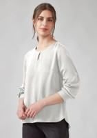 A light grey long sleeve blouse with a round neckline and a keyhole detail at the front. Features a logo.