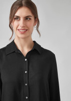 A woman's long sleeve shirt in black with a collar and button detail, featuring a model smiling.