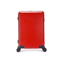 A red wheeled suitcase features a glossy finish and is equipped with dual wheels for easy mobility.