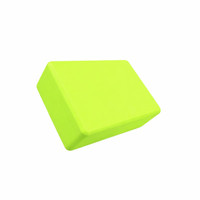 A bright green EVA yoga block with a rectangular shape, featuring a smooth surface. It has a logo on one side.