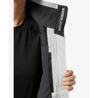 Interior detail of the Crew Women's Midlayer Jacket 2.0 in light grey featuring a fleece-lined collar, inner zip pocket, and Helly Hansen branded lining.