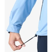 Close-up detail of the Crew Women's Midlayer Jacket 2.0 in light blue, highlighting the adjustable drawcord hem and weather-resistant fabric for a customizable fit and enhanced protection.