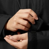 Close-up detail of the Crew Women's Midlayer Jacket 2.0 in black featuring the adjustable hook-and-loop cuff tab, weather-resistant sleeve construction, and durable performance fabric.