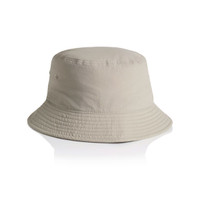 A beige nylon bucket hat with a wide brim and a logo on the side.