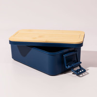 A navy double stack lunch box with a bamboo lid and a secure clasp. It has a sleek, modern design.