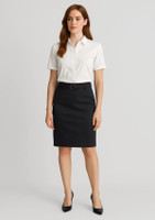 A black mid waist stretch chino skirt with a fitted design, paired with a white shirt and accessorised with a belt.