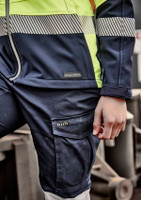 A close-up of a navy and high-visibility yellow softshell work jacket featuring a logo on the left chest and striped detailing.