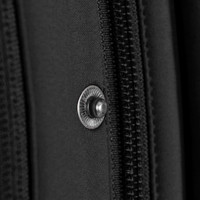 A close-up of a black jacket featuring a silver snap button and zipper details.