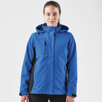 A woman wearing a blue and black 3-in-1 jacket with a hood. The jacket has a zippered pocket and features branding.
