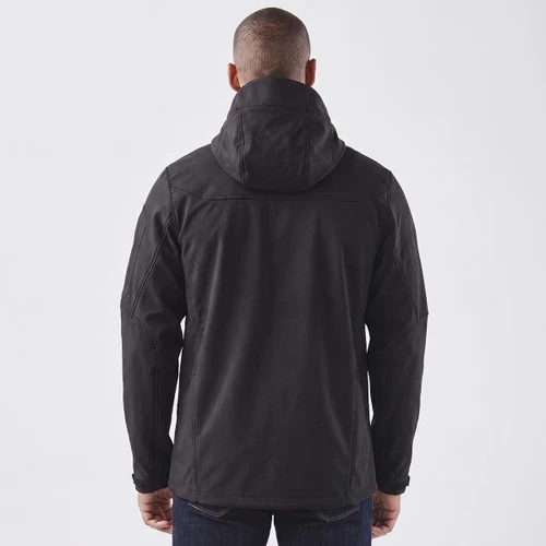 A black softshell jacket with a hood, featuring a logo, shown from the back on a model.