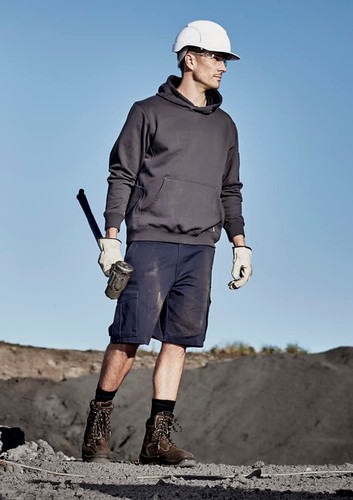 A man in a grey hoodie and navy cargo shorts stands outdoors, wearing a hard hat and gloves, holding a tool. A man in a grey hoodie and navy cargo shorts stands outdoors, wearing a hard hat and gloves, holding a tool.