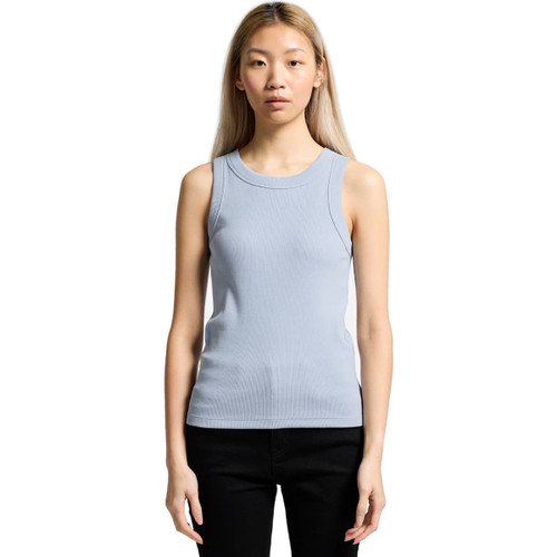 A light blue organic rib tank top with a fitted design and no sleeves. The model stands against a white background. A light blue organic rib tank top with a fitted design and no sleeves. The model stands against a white background.