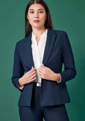 A navy single-button mid-length jacket with a tailored fit, styled with a white blouse. Features branding on the jacket. A navy single-button mid-length jacket with a tailored fit, styled with a white blouse. Features branding on the jacket.