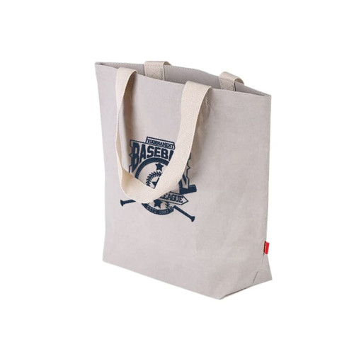 A large, light brown washable kraft paper bag with a cotton handle and a logo printed on the front. A large, light brown washable kraft paper bag with a cotton handle and a logo printed on the front.