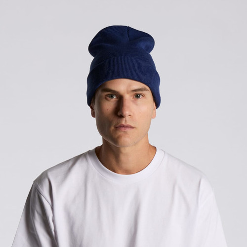 A navy cuff beanie worn by a model, featuring a relaxed fit and a simple design. A navy cuff beanie worn by a model, featuring a relaxed fit and a simple design.