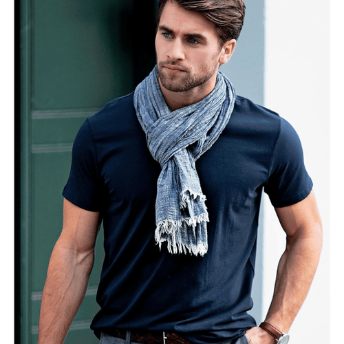 A navy Montauk Men T-Shirt worn with a light scarf and grey trousers, featuring a logo.