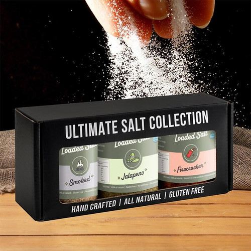 Ultimate Salt Collection featuring Smoked, Jalapeño, and Firecracker flavors in handcrafted, gluten-free packaging, set against a textured background with salt being sprinkled.