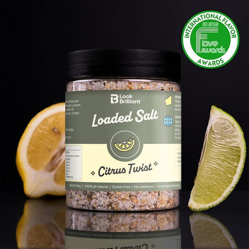 Jar of Smokey Joe's Loaded Salt Citrus Twist, featuring a blend of natural seasonings, alongside fresh lemon and lime wedges, set against a dark background.