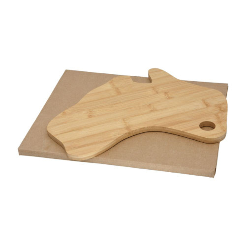 A bamboo cheese board shaped like Australia, resting on a brown cardboard base.