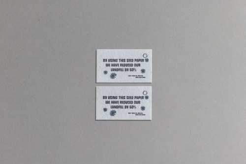 Two rectangular seed paper business cards in light grey with blue text and a circular logo, promoting sustainability. Two rectangular seed paper business cards in light grey with blue text and a circular logo, promoting sustainability.