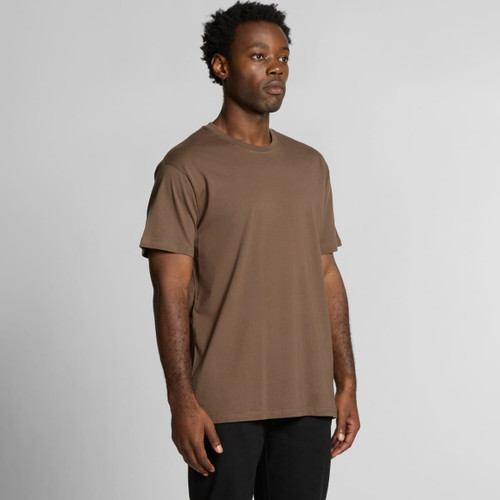 A brown organic t-shirt displayed on a model, featuring a simple design and a logo. A brown organic t-shirt displayed on a model, featuring a simple design and a logo.