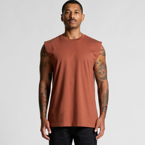A man wearing a sleeveless, burnt orange tank top with a plain design. The top has a logo on it. A man wearing a sleeveless, burnt orange tank top with a plain design. The top has a logo on it.