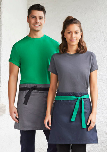 A green and navy urban waist apron worn by two models, featuring contrasting ties and a logo on one apron.