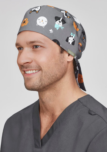 A unisex printed scrub cap in grey with various animal illustrations, featuring a tied back design.